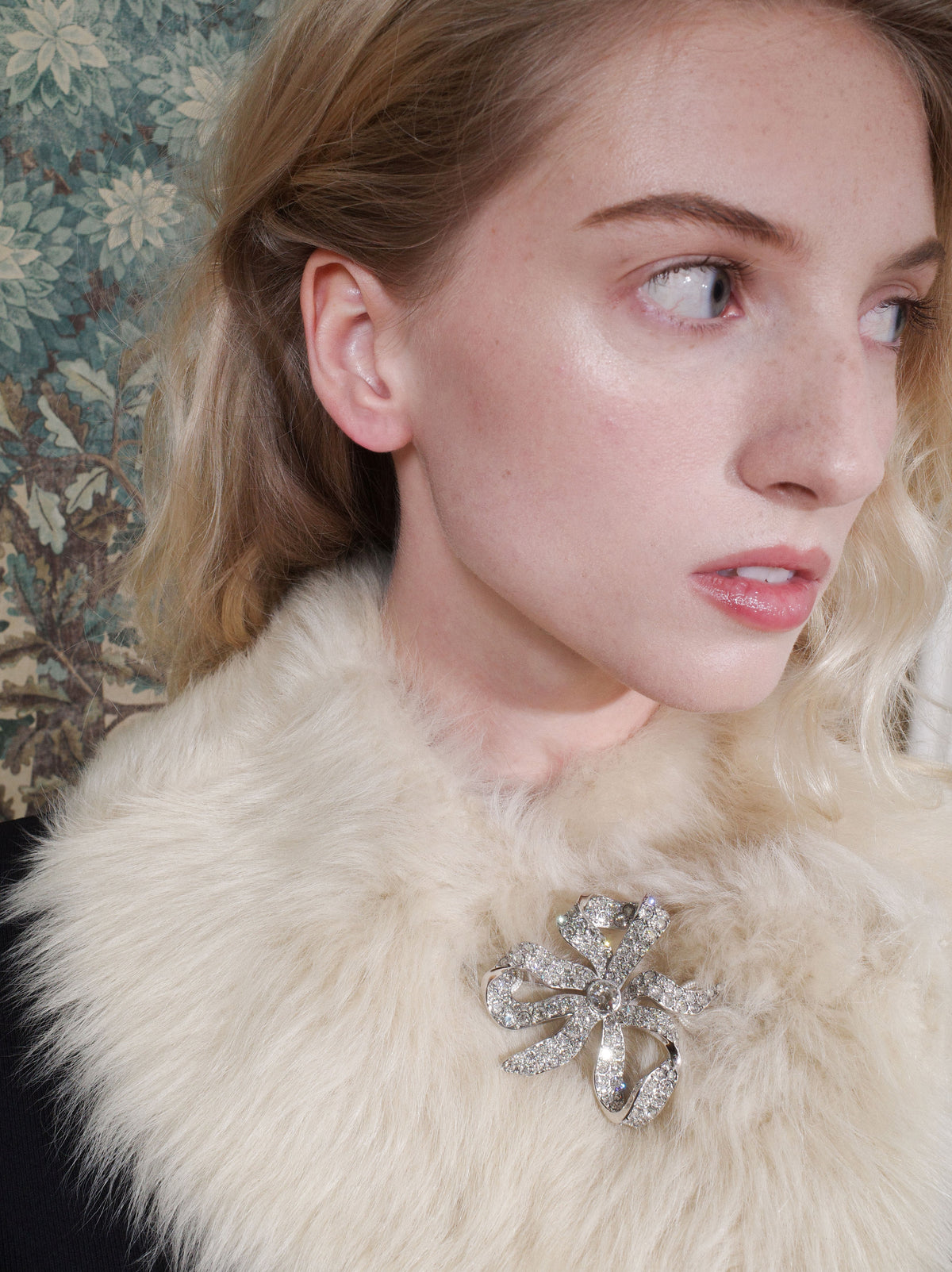 Seidler Vivienne Bow Brooch worn on a cream shearling collar
